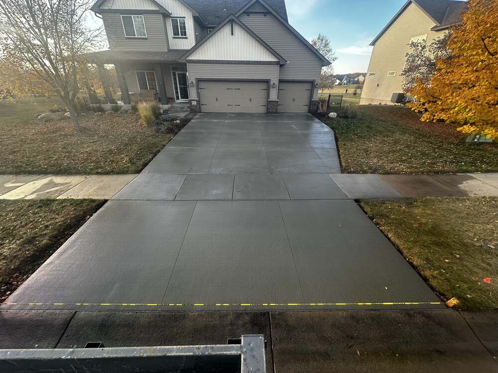 New three-stall concrete driveway with apron and sidewalk tie-in in St. Bonifacius, MN