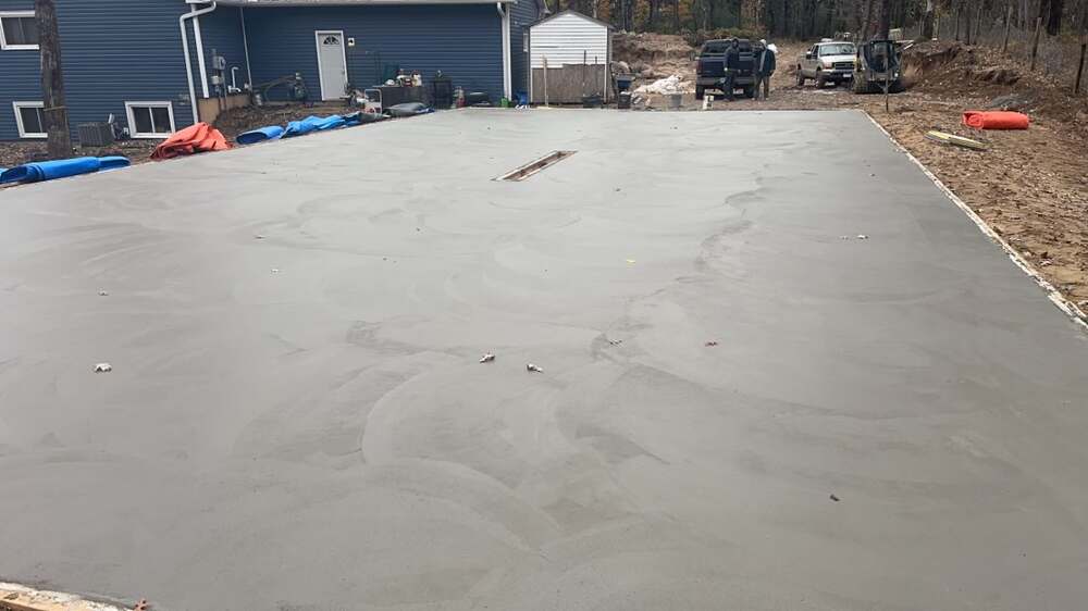 Garage floor slab freshly poured with center trench drain